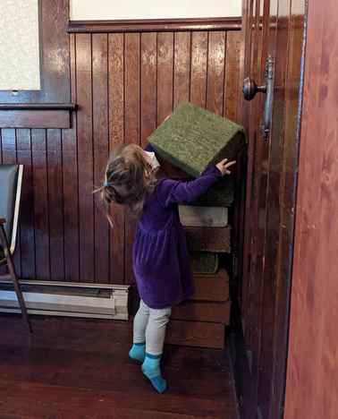 Child helping to tidy up the Meetinghouse